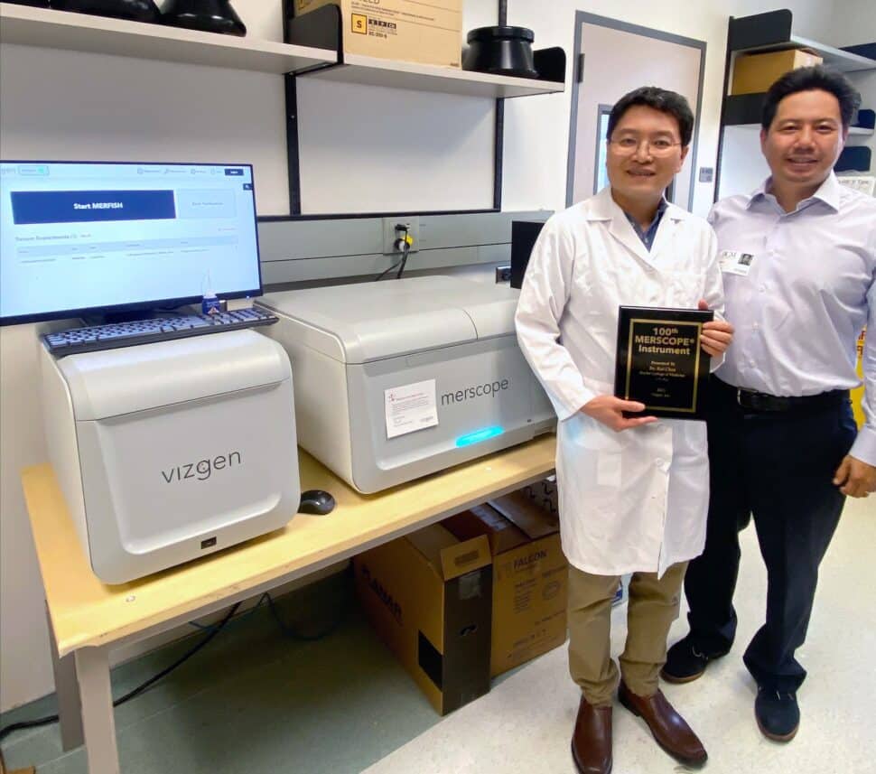 FIGURE 1: Dr. Rui Chen (left) and Vizgen CEO Terry Lo (right) standing next to the new MERSCOPE instrument in Dr. Chen’s Core laboratory at the Baylor College of Medicine. 